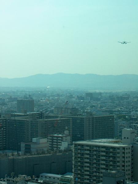 Out the window of the 19th floor, aircraft on final for the Osaka airport