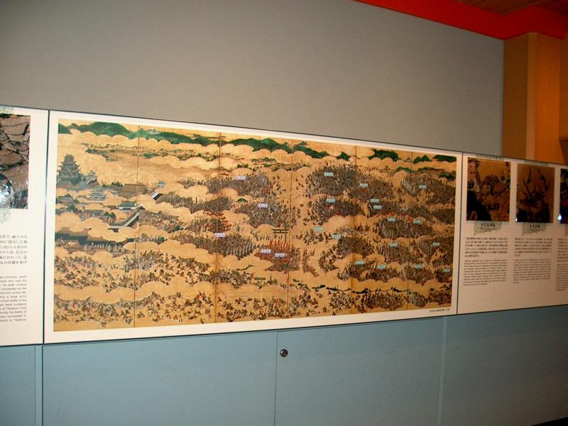 Folding screen painting of one of the wars, beseiging the castle