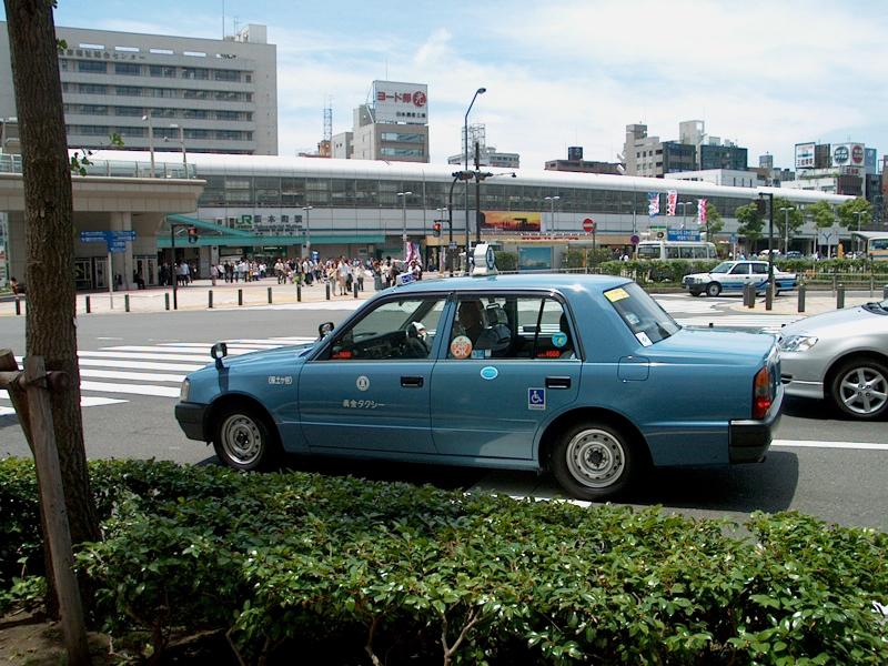 A better shot of a taxi with the way-forward side mirrors - they don't stick out as far for the narrow streets?  Every taxi has its mirrors this way.